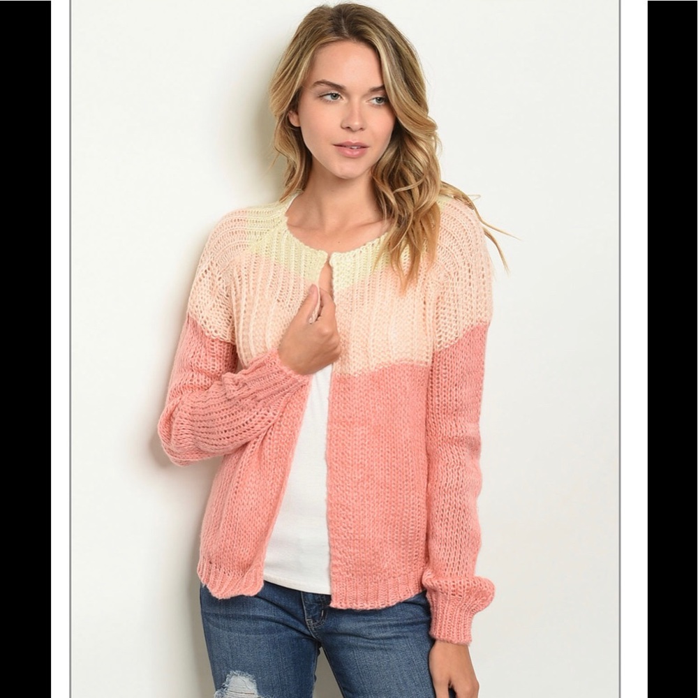 Soft pink/peach cardigan.